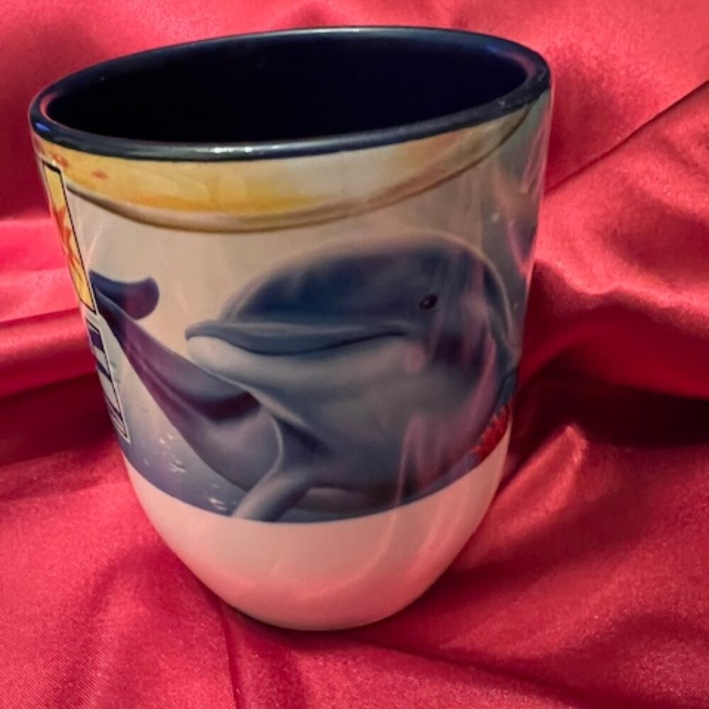Ceramic coffee mug with a "Cancun"‎ design with a beautiful Dolphin. Colorful